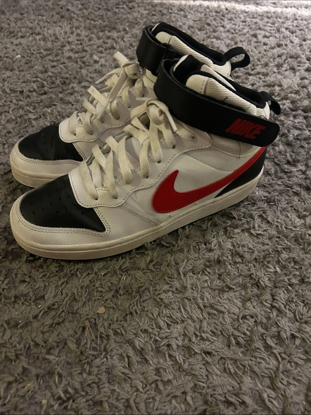 Nike White High-Top Sneakers with Black Toe and Red Swoosh Accent